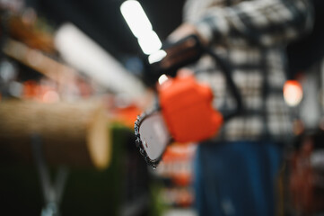 Man holds electric saw in tool store