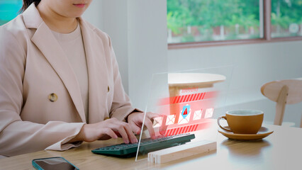 Businesswoman receiving a cybersecurity warning about a phishing email scam and malware attack on a futuristic holographic interface, illustrating a data breach and internet security threat.