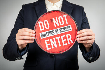 Person holding anti bullying school signboard concept