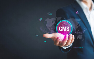 Fototapeta premium Businessman holding CMS for Content Management System technology.