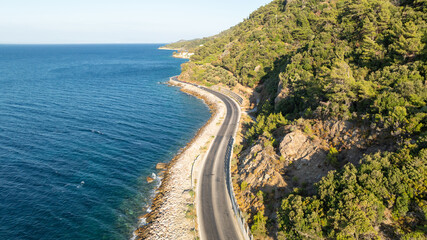 Aerial view of apshalt road next to the sea