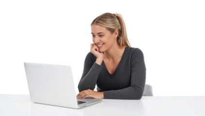 Smiling blonde woman using a laptop, sitting at a white desk against isolated transparent backdrop
