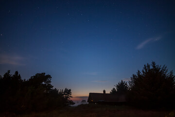 night sky with stars, house, chimney, fog