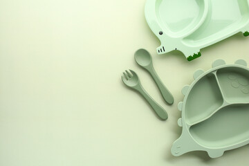 Obraz na płótnie Canvas Mint green animal-shaped kids plates on pastel background