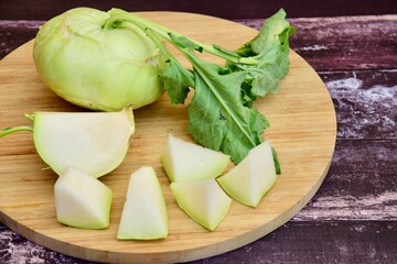 Whole ripe kohlrabi plants on wooden table