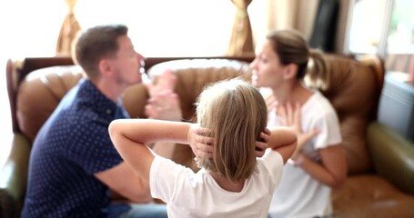 Little girl with hands over ears stands opposite parents arguing loudly on couch. Family conflict and negative impact of parental disputes on children - Powered by Adobe