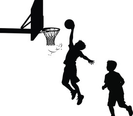 Silhouette of a basketball player dunking the ball with another player running