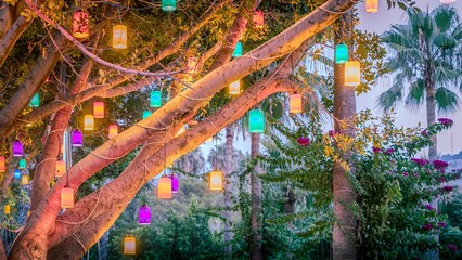 Colorful lanterns in a garden setting. © Wirestock