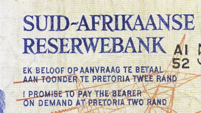 Macro slow pan over South African Reserve Bank text on a vintage two rand note