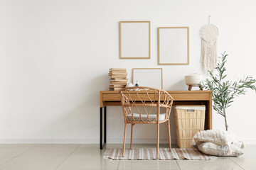Interior of beautiful room with workplace, frames, chair and olive tree