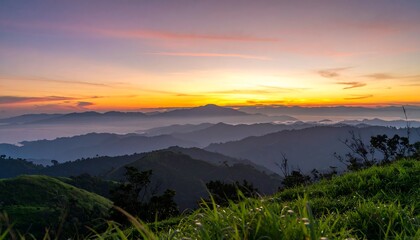 Fototapeta premium A breathtaking vista of layered mountain ranges bathed in a vibrant sunrise.
