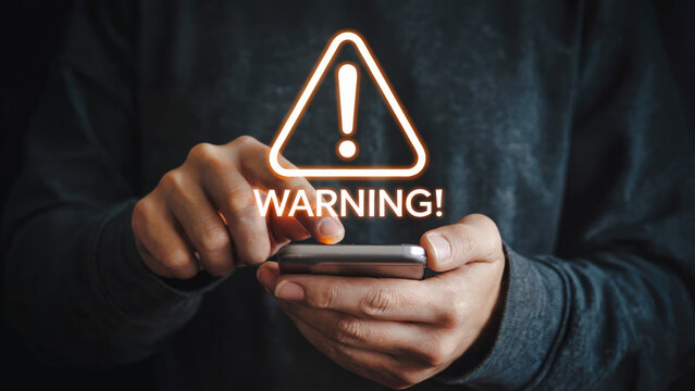 Urgent warning alert on smartphone screen, cybersecurity threat notification for digital safety