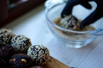 Vegan date nut raisin cocoa sweets on white plate