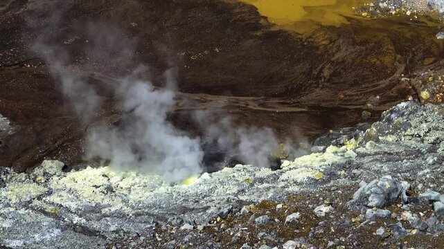 A volcano crater with an acid lake (explosion lake) and steaming fumaroles and hot springs. Sulawesi. Indonesia