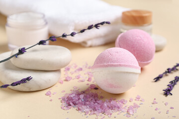 Composition with bath bombs, cosmetic products and sea salt on color background