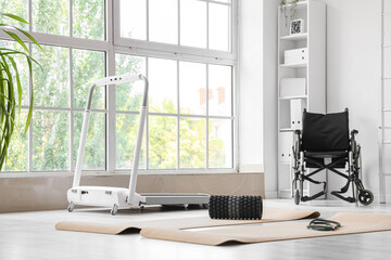 Interior of physiotherapist's office with sports equipment and wheelchair