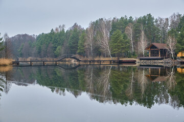 Lakeside House and Bridge with Forest Reflection