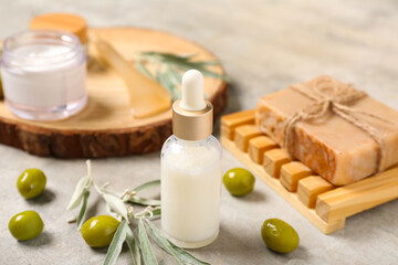 Natural cosmetic products and green olives on grunge background