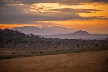 Naklejka premium African Savannah Sunset with Mountain Silhouette