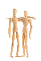 Wooden mannequins hugging on white background