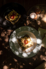 Breakfast toast with avocado and eggs, sunlight and bokeh