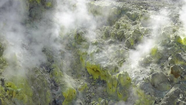 A volcano crater with an acid lake (explosion lake) and steaming fumaroles (solfatare) and hot springs. Sulawesi. Indonesia