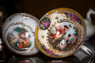 Antique porcelain bowls and cups in a flea market