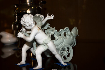 Sculptures of angels on the background of a samovar
