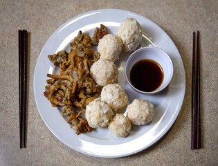 Asian dumplings with soy sauce in small serving bowls