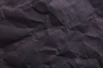 Crinkled black paper texture with subtle shadows and intricate folds