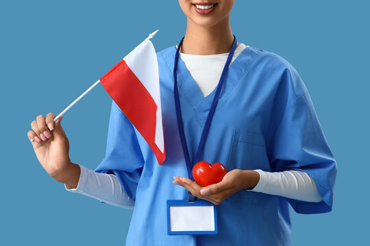 Female doctor with flag of Poland and heart on blue background