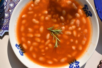 Close-up Delicious White Bean Soup with Rosemary Garnish top view