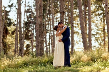 Romantic Wedding Couple Embracing in a Serene Forest Setting During Sunset