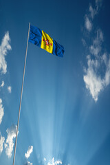 Waving National flag of Madeira on flagpole in sky