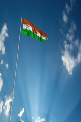 Waving National flag of Niger on flagpole in sky