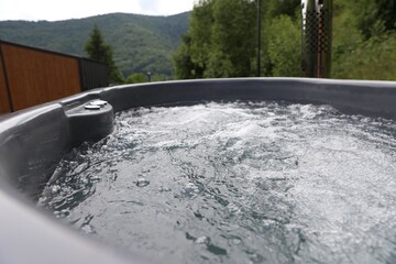 Tub with hot water at luxury resort in mountains, closeup