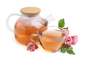 Tasty rose tea in glass cup, teapot and flowers isolated on white