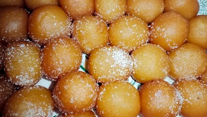 Sweets desert,rose berries,Colorful traditional Indian sweets for the Holi festival, including gulab jamun and other candied delicacies. Celebrate with these mouth-watering
