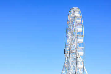 Giant ferris wheel against clear blue sky