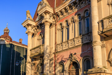 Fototapeta premium Historic european architectural facade with ornate columns and decorative details at sunset