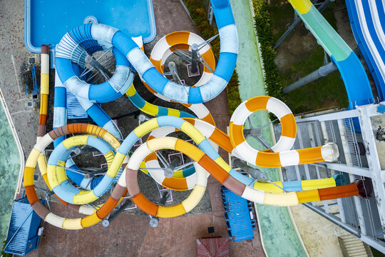 Aerial view of swirling, brightly colored water slides twisting and turning in a vibrant display of aquatic amusement, Kuah, Langkawi, Malaysia.