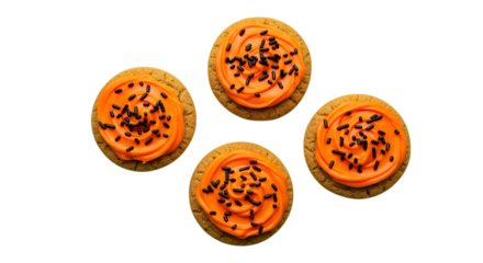 Sweet Halloween treats four frosted cookies with festive orange icing and black sprinkles arranged for a delightful holiday celebration