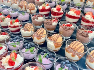 A tempting display of beautifully decorated desserts arranged on a table, including cakes, pastries, and sweets with colorful toppings. Perfect for themes of celebration, indulgence, bakery art, and c