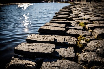 Cobblestone path edging a dark lake
