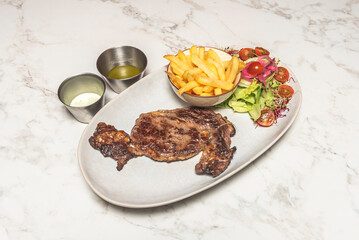 Ávila ribeye steak with designation of origin, served with rustic potatoes and roasted piquillo peppers