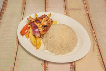 Peruvian lomo saltado, wok-prepared with a dark soy sauce and vinegar sauce, served in a bowl to retain its juice