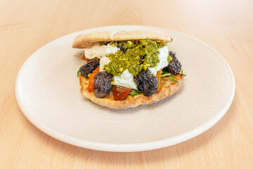 Delicious pulled pork sandwich with cabbage and carrot slaw, served on a brioche bun with barbecue sauce