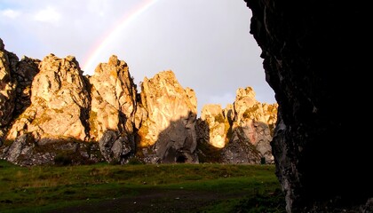 Rainbow over rocky landscape