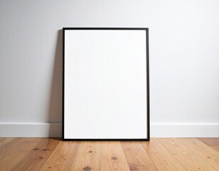 Black Framed Blank Poster Mockup Leaning Against White Wall On Wooden Floor with Soft Lighting