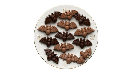 Fototapeta premium Delightful assortment of milk and dark chocolate bat candies arranged artistically on a decorative white plate, perfect for Halloween celebrations.